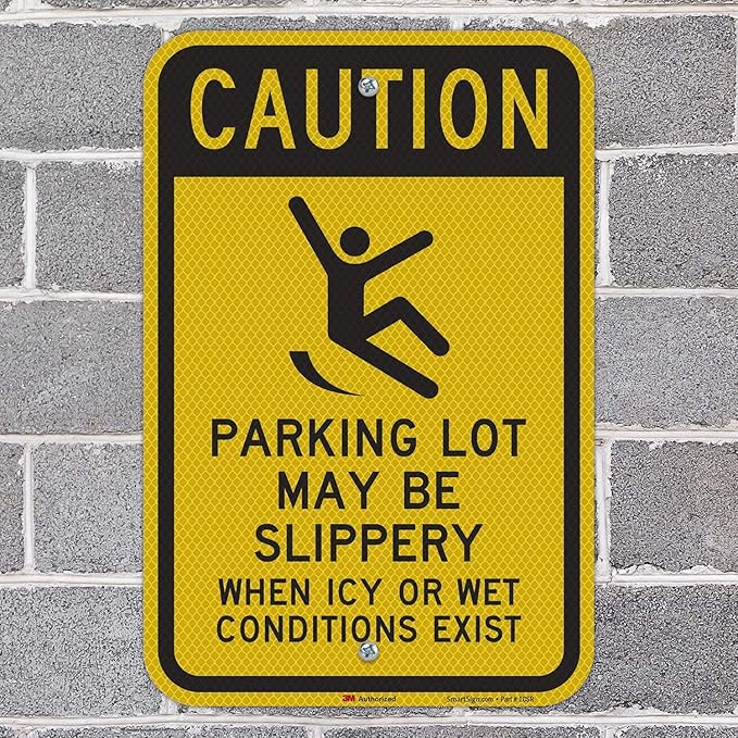 SmartSign 18 x 12 inch “Caution - Parking Lot May Be Slippery When Icy Or Wet Conditions Exist” Metal Sign, 63 mil Aluminum, 3M Laminated Diamond Grade Reflective Material, Black and Yellow, USA-Made